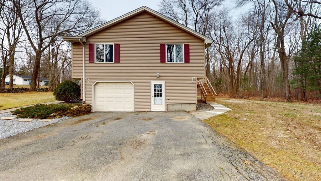 91 Dodge Hill Road Sutton, MA 01590 - Photo 4 of 42 a view of a house with a yard covered in snow