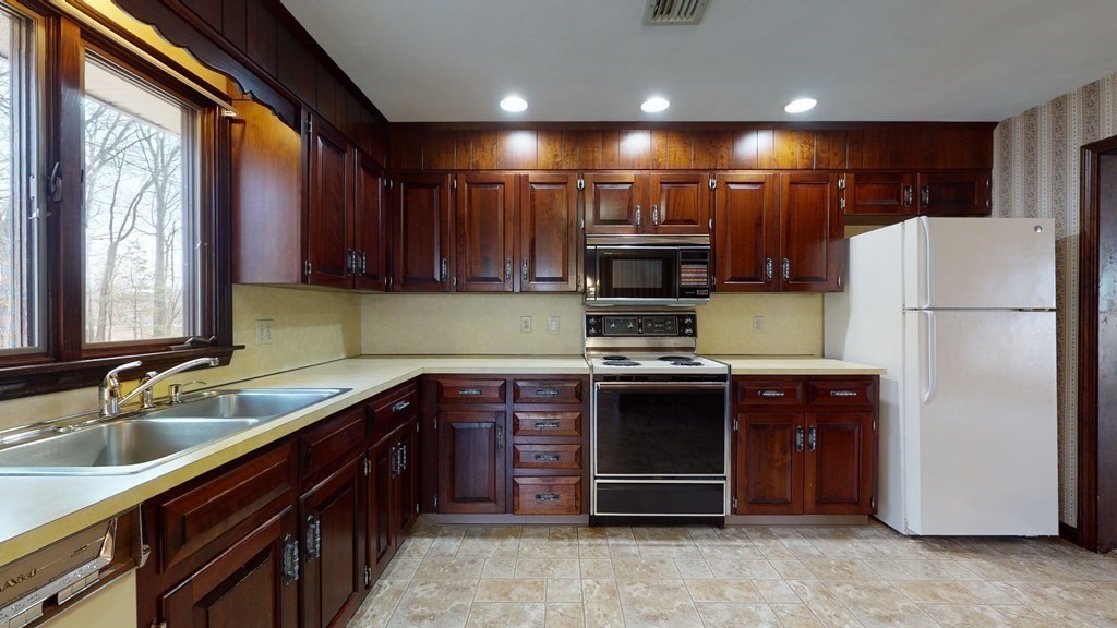91 Dodge Hill Road Sutton, MA 01590 - Photo 10 of 42 a kitchen with stainless steel appliances granite countertop a refrigerator a sink and a stove