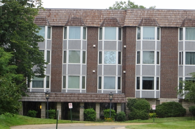 2600 Windsor Mall, Unit 3A Park Ridge, IL 60068 - Photo 1 of 18 a view of a brick building next to a yard