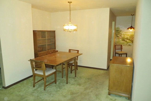 2600 Windsor Mall, Unit 3A Park Ridge, IL 60068 - Photo 10 of 18 a view of a dining room with furniture and chandelier