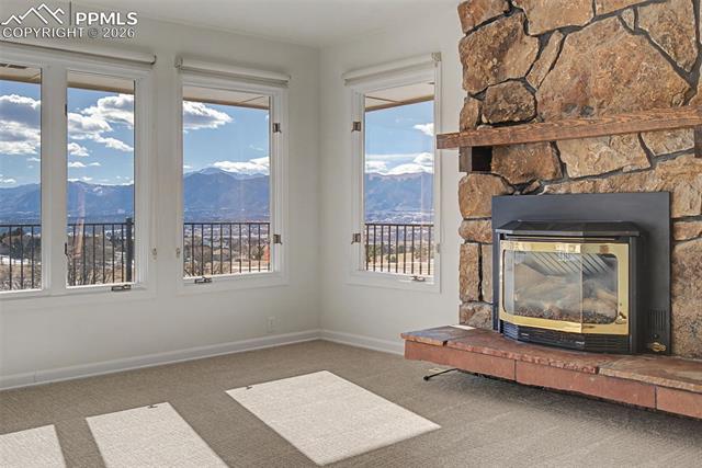 733 Bowstring Road Monument, CO 80132 - Photo 10 of 45 Sit by the fire and gaze at Pikes Peak!