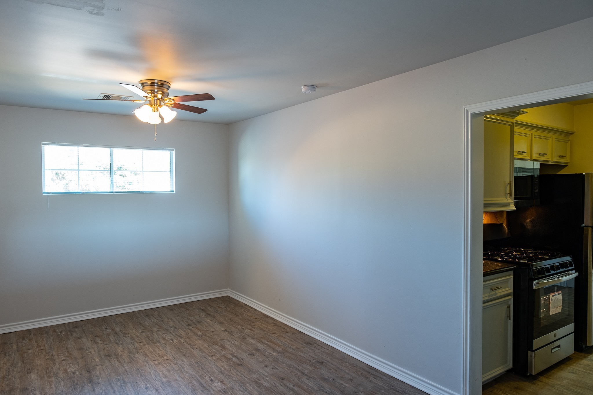 2801 Carrolton Street, Unit 3 Houston, TX 77023 - Photo 7 of 10 wooden floor in an empty room with a window