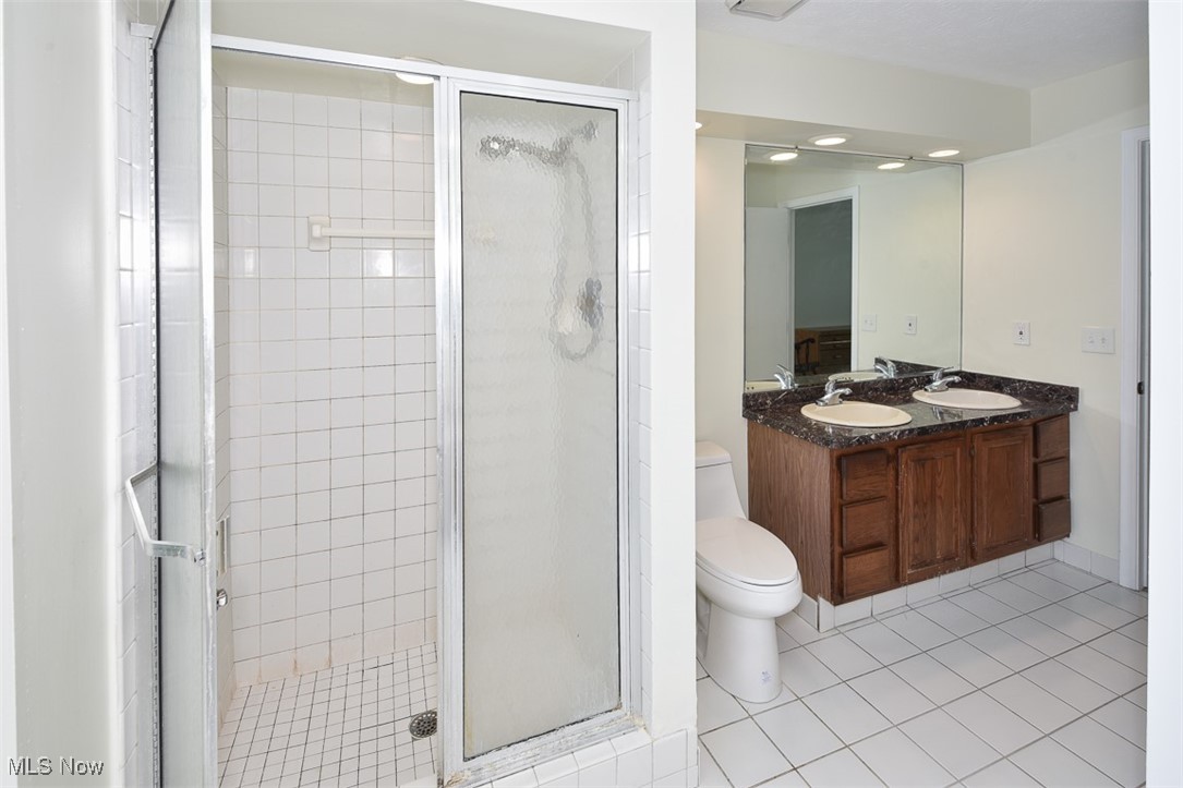 30776 Cedar Road Cleveland, OH 44124 - Photo 23 of 41 Bathroom featuring a shower stall, tile patterned floors, and double vanity