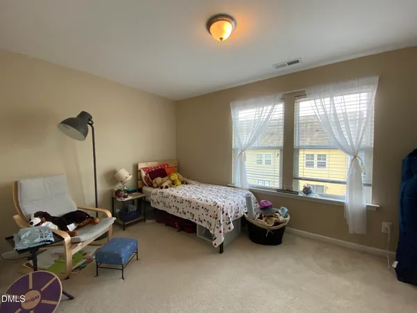 a bed room with a bed and a window