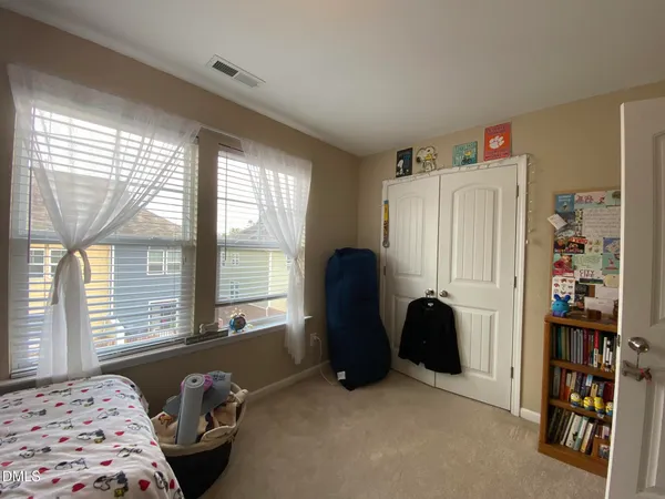 a bedroom with a bed and a large window