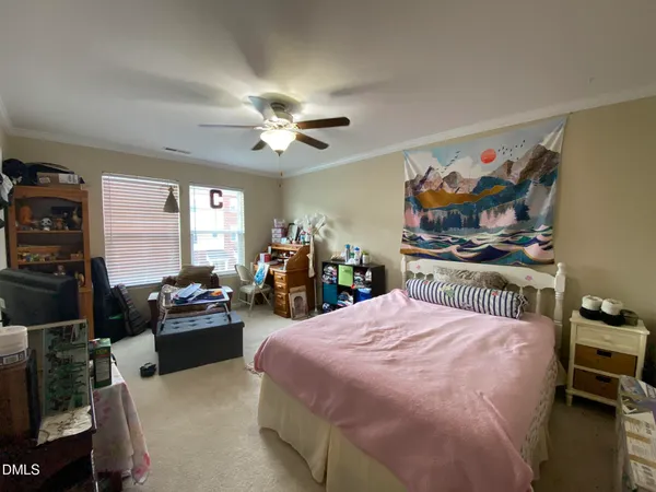 a bedroom with a bed and a chandelier