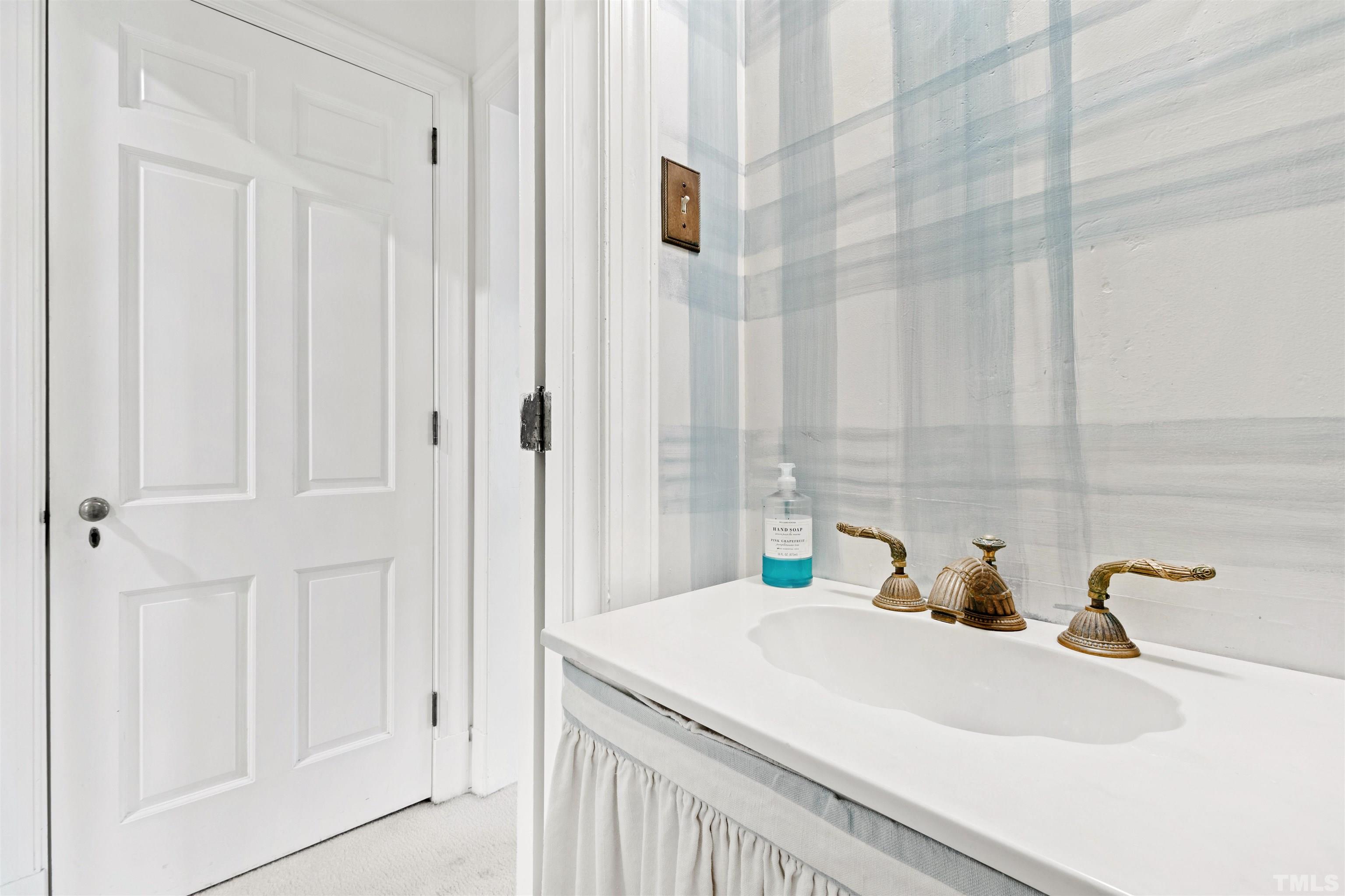 3231 Sussex Road Raleigh, NC 27607 - Photo 18 of 60 a bathroom with a sink and a shower