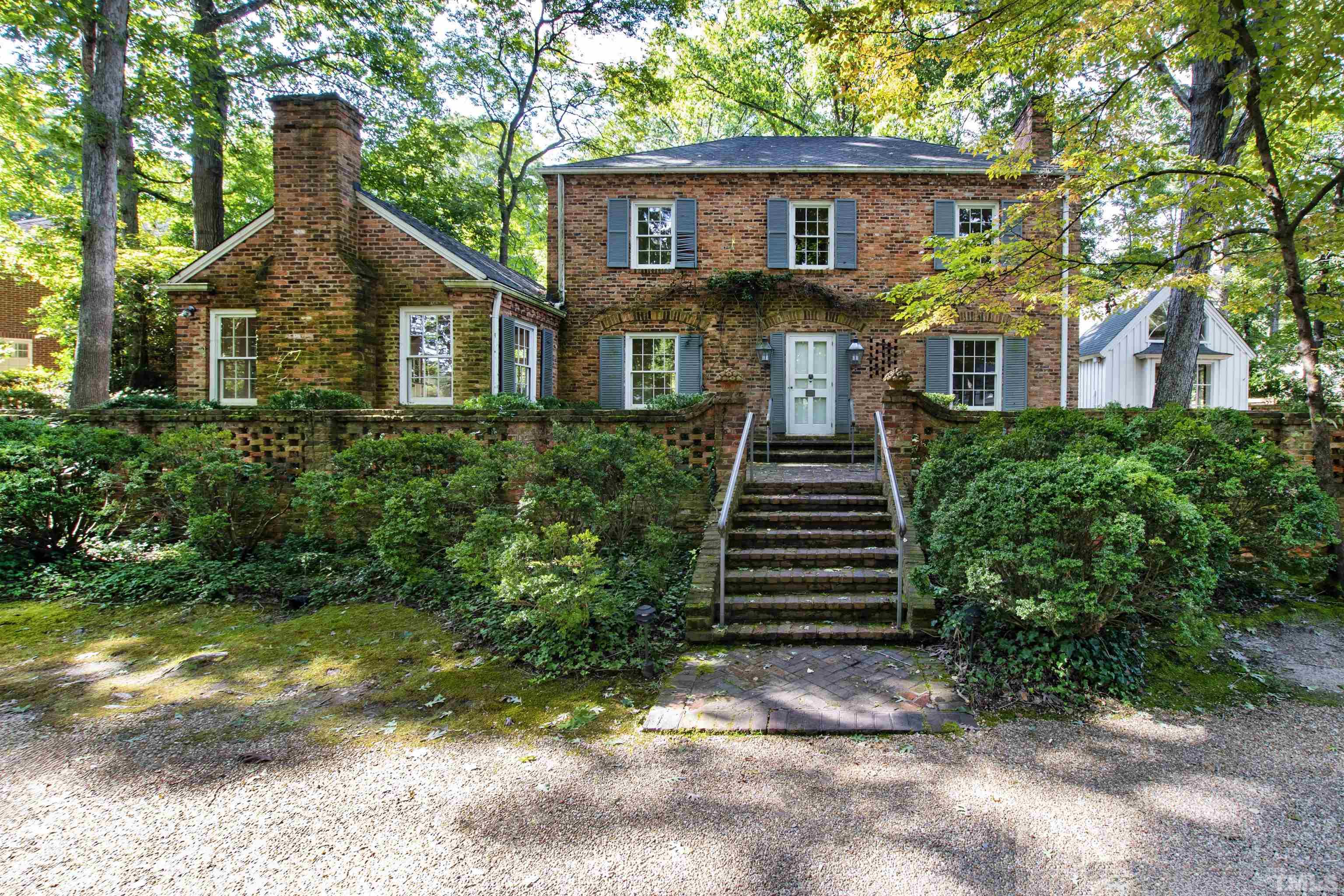 3231 Sussex Road Raleigh, NC 27607 - Photo 2 of 60 a front view of a house with a yard and garage