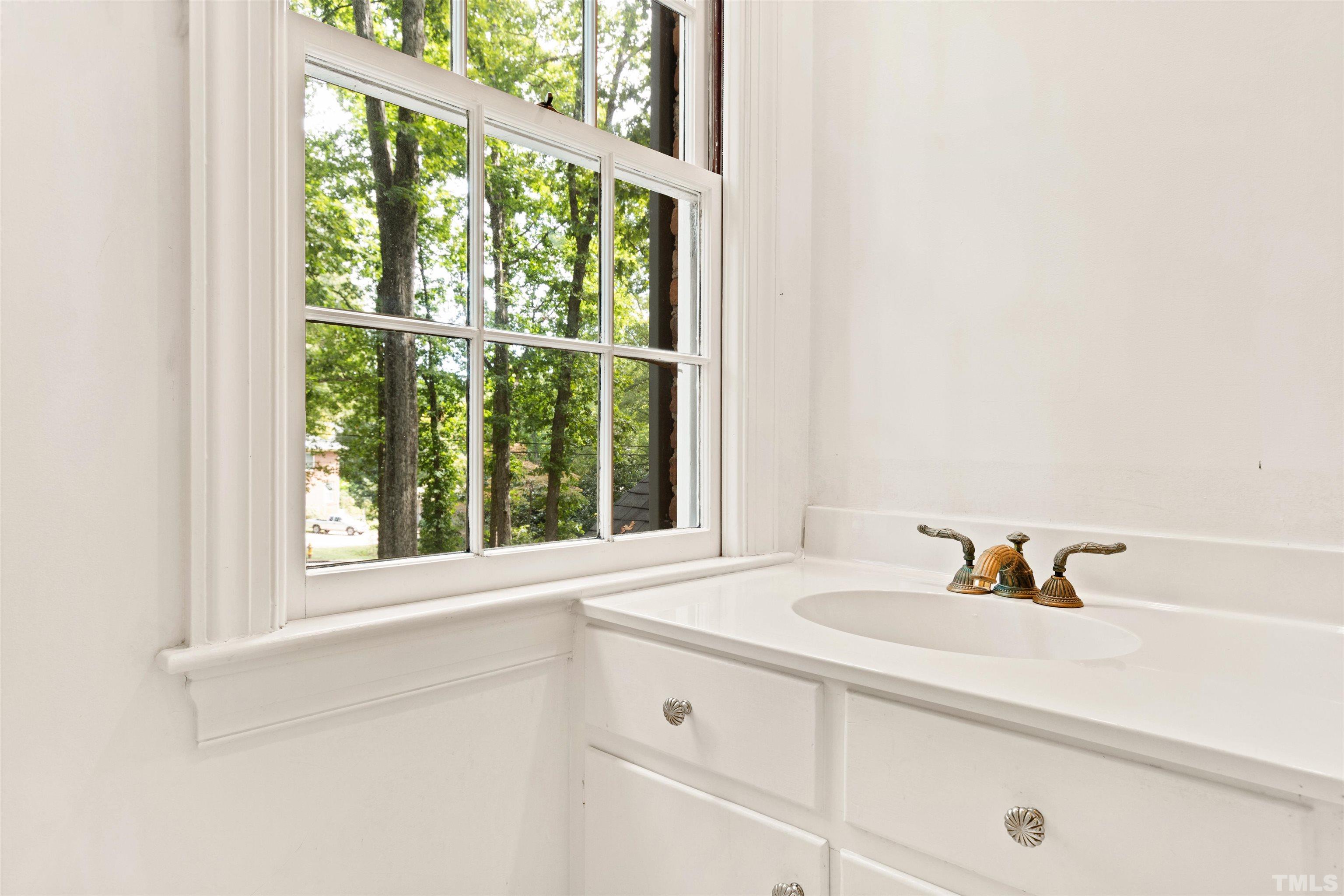 3231 Sussex Road Raleigh, NC 27607 - Photo 24 of 60 a bathroom with a sink and a window