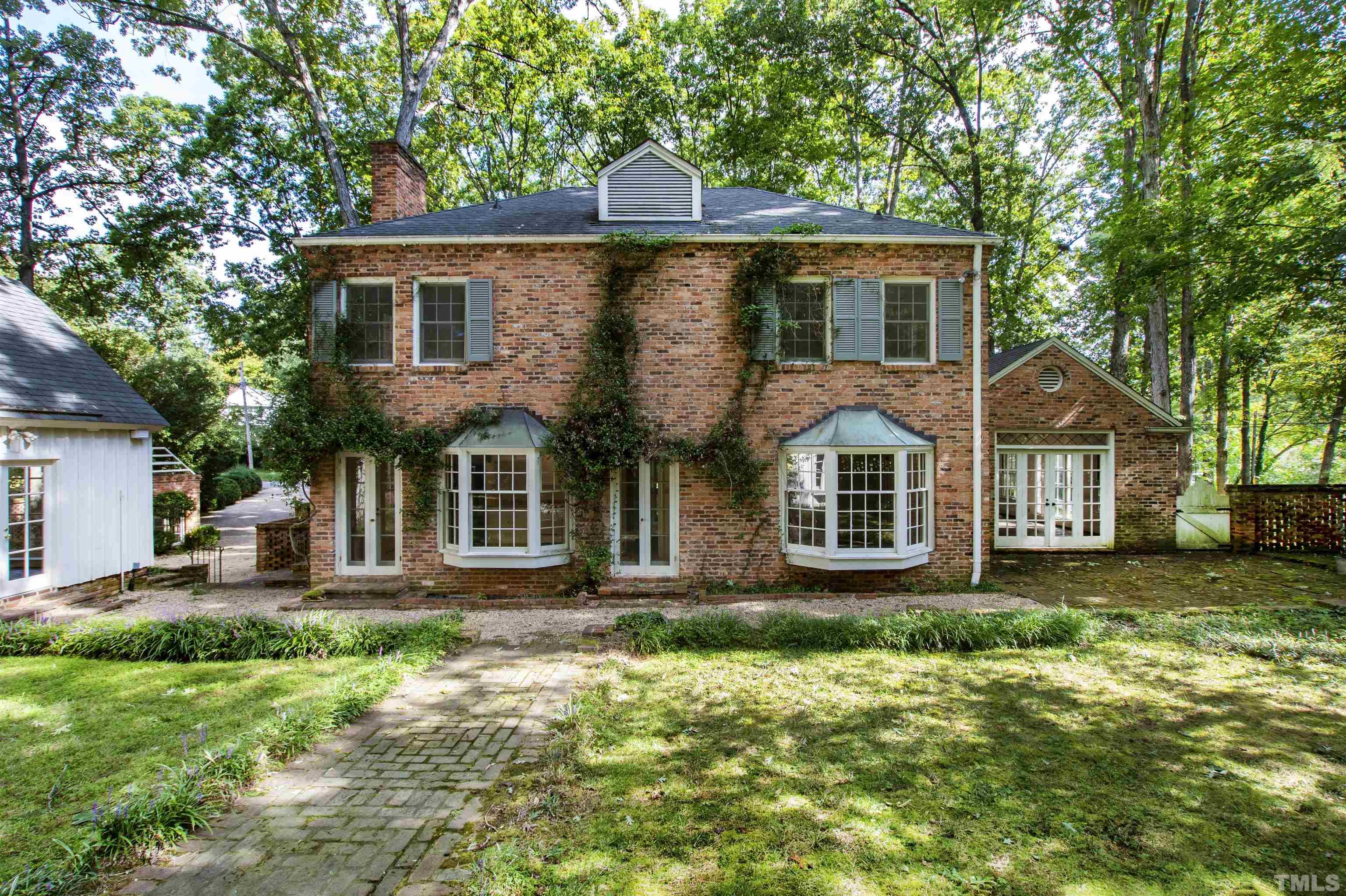3231 Sussex Road Raleigh, NC 27607 - Photo 36 of 60 a front view of a house with a yard