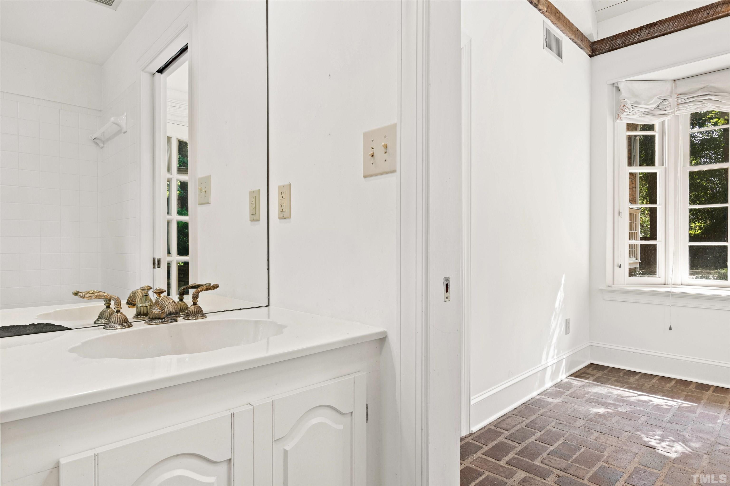 3231 Sussex Road Raleigh, NC 27607 - Photo 46 of 60 a bathroom with a sink and a mirror