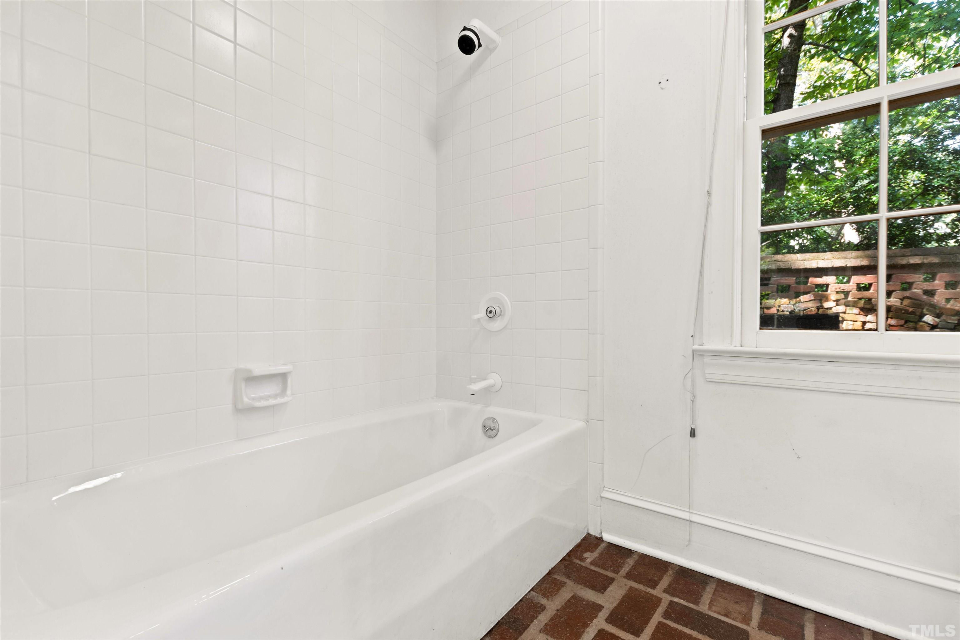 3231 Sussex Road Raleigh, NC 27607 - Photo 47 of 60 a white bath tub sitting next to a window