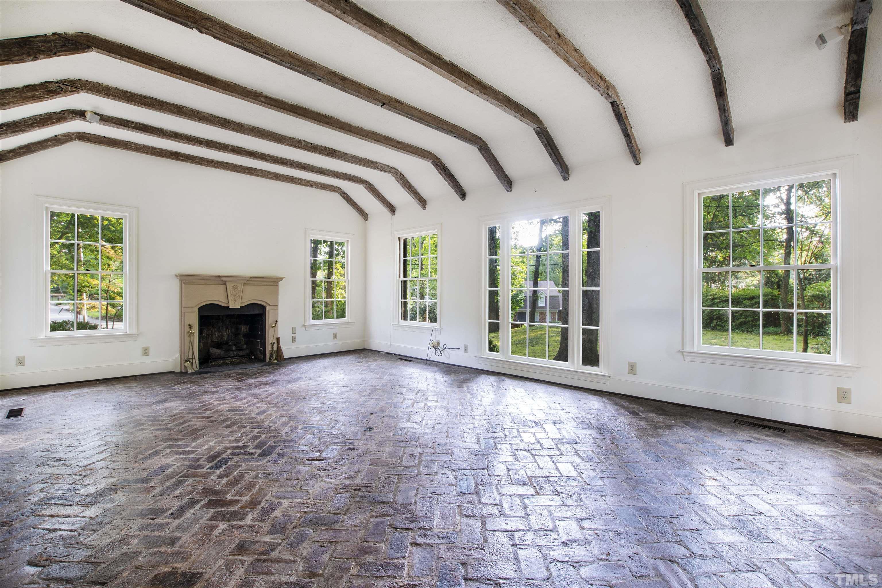 3231 Sussex Road Raleigh, NC 27607 - Photo 5 of 60 a view of livingroom with window and fireplace