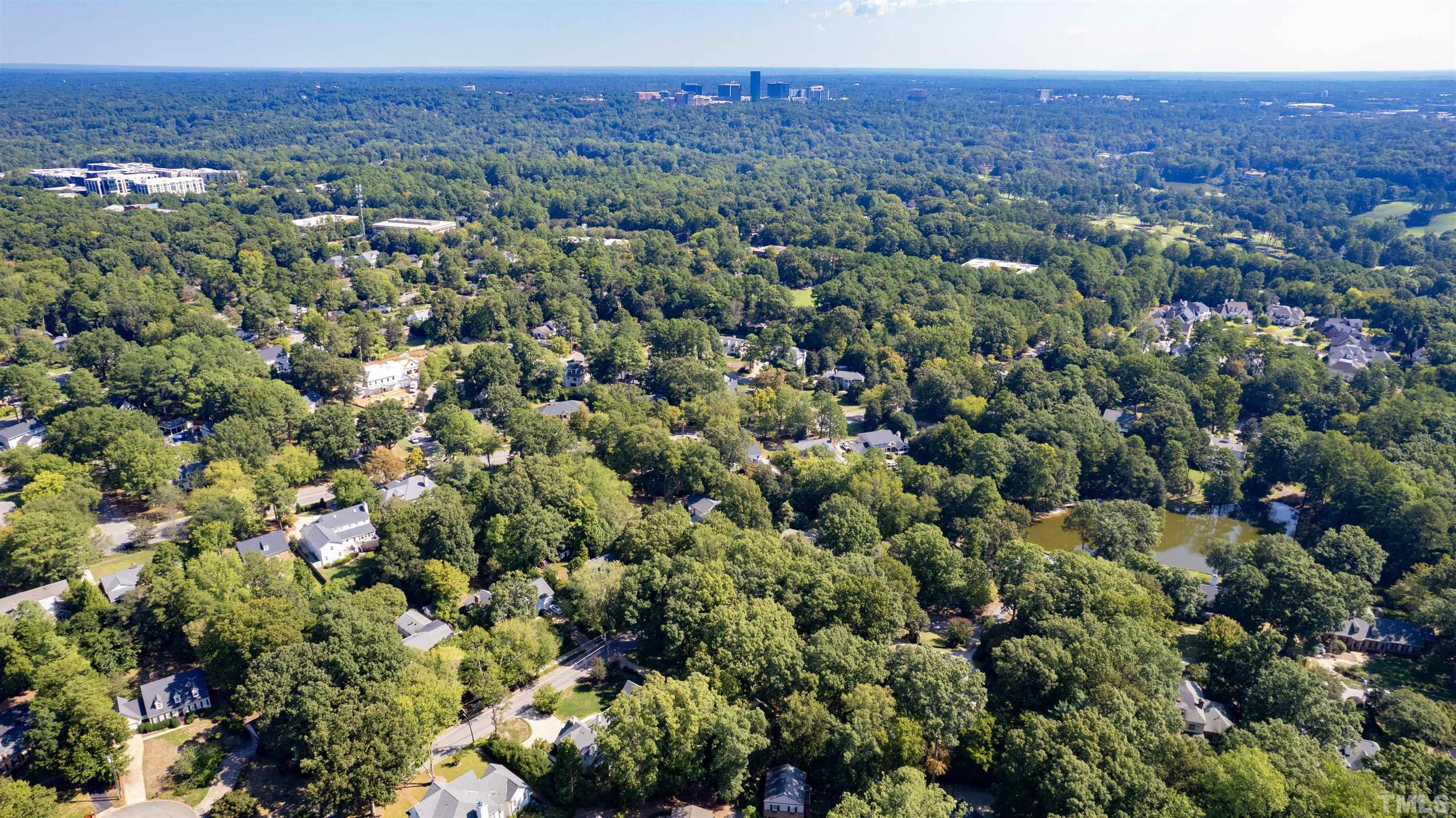 3231 Sussex Road Raleigh, NC 27607 - Photo 56 of 60 a view of a city with lush green forest