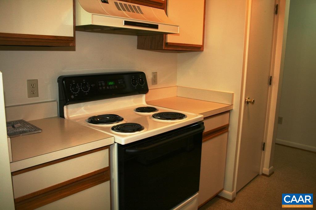 117 Turtle Creek Road, Unit 10 Charlottesville, VA 22901 - Photo 8 of 12 a kitchen with a stove and a refrigerator