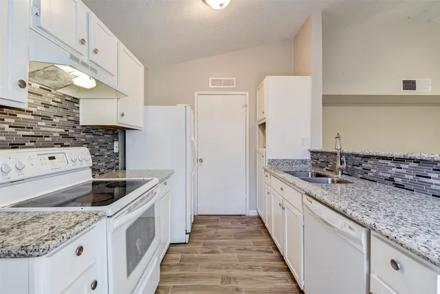a kitchen with a sink and cabinets