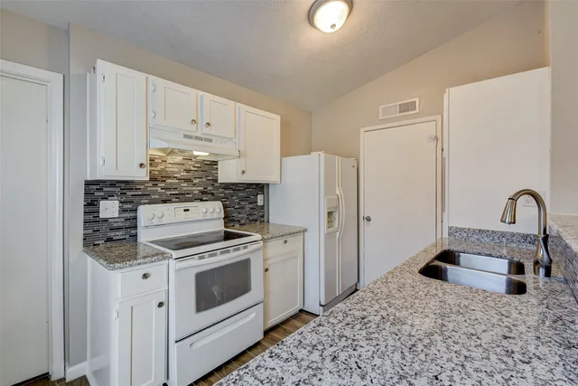 a kitchen with a stove and a refrigerator