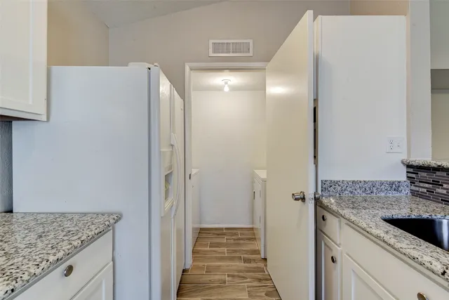 a view of a kitchen from the hallway