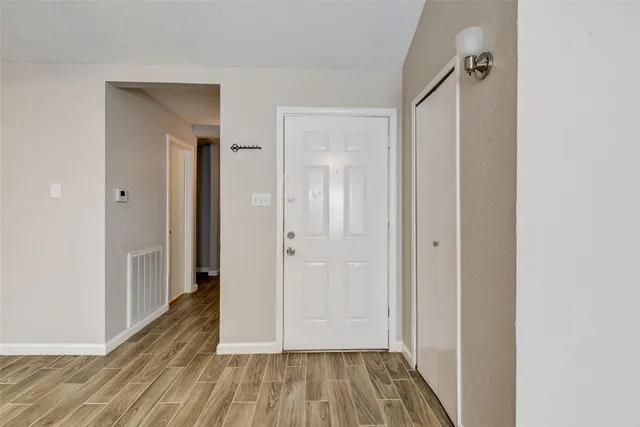 a view of a hallway with wooden floor