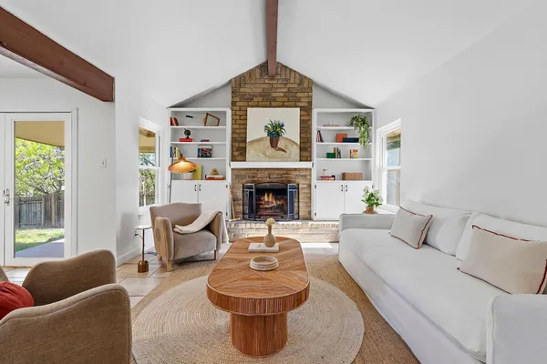 a living room with furniture and a fireplace