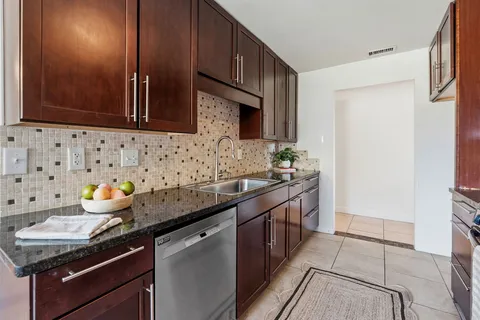 a kitchen with stainless steel appliances a sink stove and cabinets