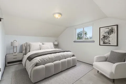 a spacious bedroom with a bed and a couch