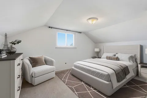 a bedroom with a bed and a couch