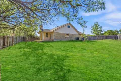 a front view of a house with yard and green space