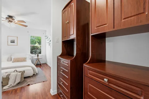 a view of living room with furniture and wooden floor