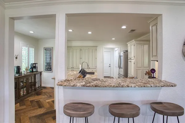 a bathroom with a granite countertop sink a toilet and a mirror