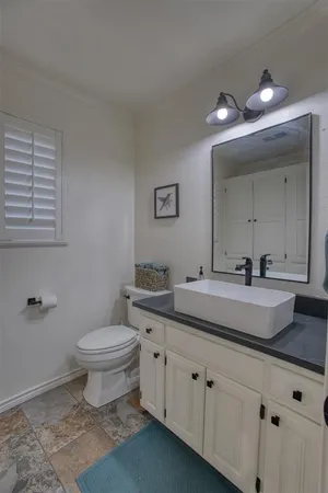 a bedroom with a bed and a chandelier fan