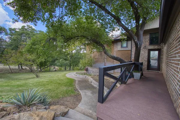 a view of backyard with outdoor seating and green space