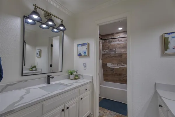 a spacious bedroom with a bed and a chandelier