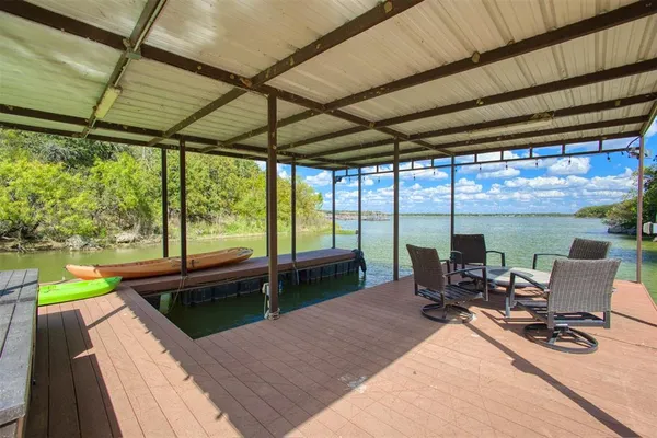 a sitting area with lake view and a floor to ceiling window