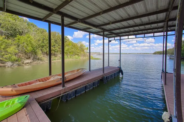 a view of a backyard with plants and a slide