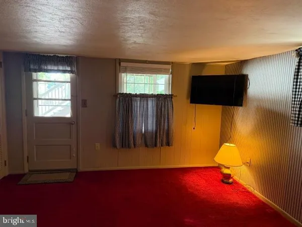 a view of room with furniture and a ceiling fan