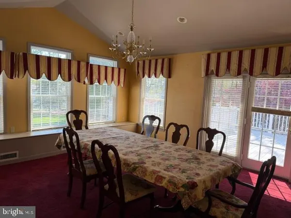 a view of a livingroom with an empty space and a window