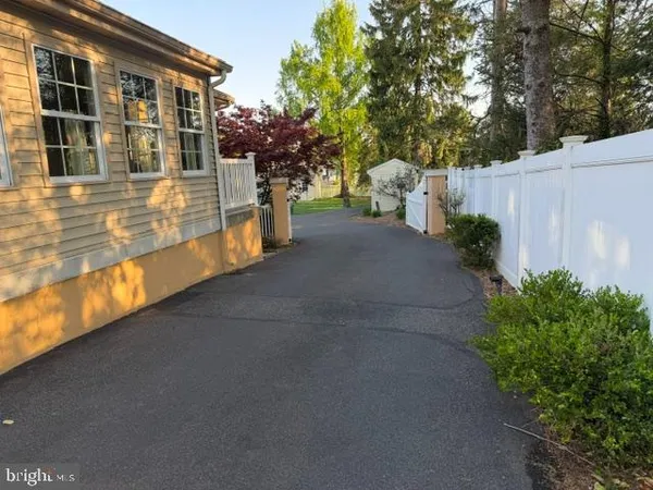 a front view of a house with a yard and potted plants