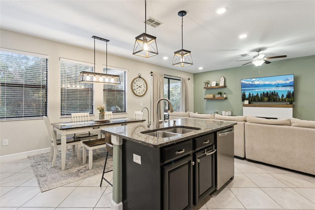 8816 Shady Pavillion Court Land O Lakes, FL 34637 - Photo 12 of 64 a kitchen with a stove and a clock on the wall