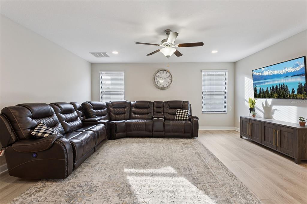 8816 Shady Pavillion Court Land O Lakes, FL 34637 - Photo 21 of 64 a living room with furniture and a flat screen tv