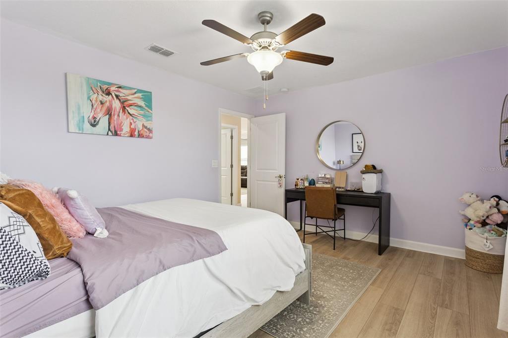 8816 Shady Pavillion Court Land O Lakes, FL 34637 - Photo 26 of 64 a bedroom with bed and a chandelier