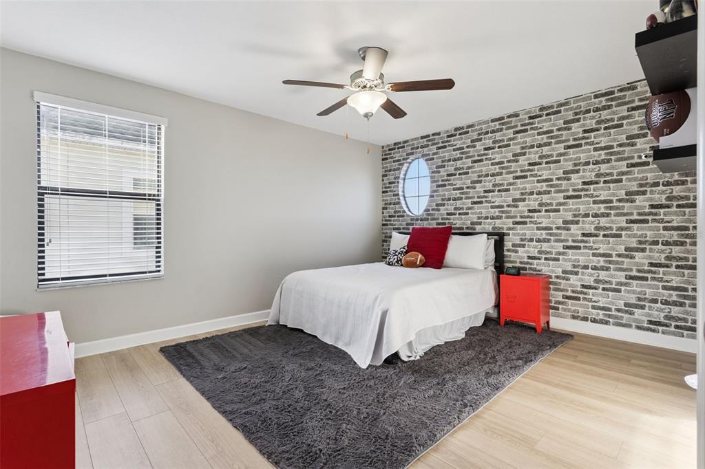 8816 Shady Pavillion Court Land O Lakes, FL 34637 - Photo 29 of 64 a bedroom with a bed and a potted plant