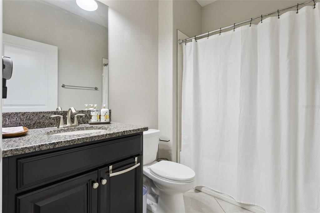 8816 Shady Pavillion Court Land O Lakes, FL 34637 - Photo 38 of 64 a bathroom with a granite countertop sink and a mirror