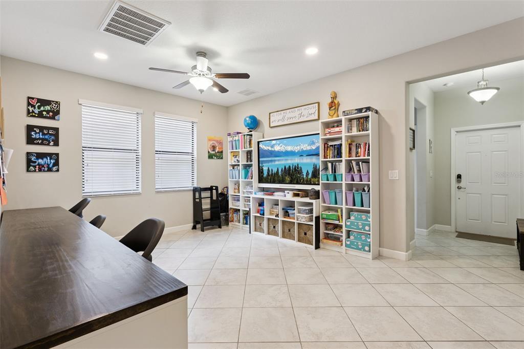 8816 Shady Pavillion Court Land O Lakes, FL 34637 - Photo 40 of 64 a living room with furniture and a flat screen tv