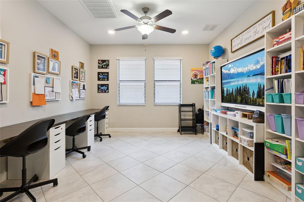 8816 Shady Pavillion Court Land O Lakes, FL 34637 - Photo 41 of 64 a view of a workspace with furniture and a book shelf