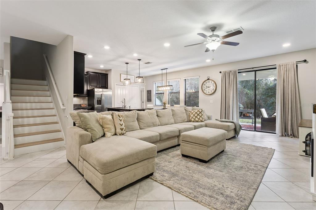 8816 Shady Pavillion Court Land O Lakes, FL 34637 - Photo 9 of 64 a living room with furniture and a chandelier