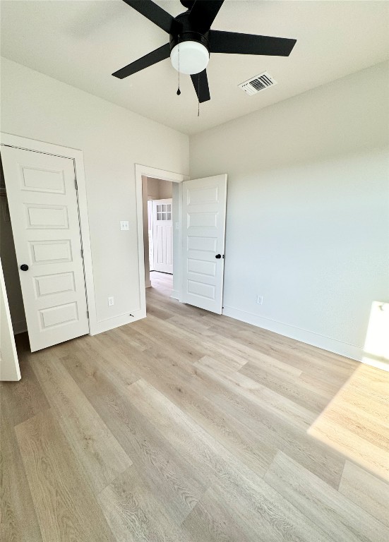 100 Zayd Court, Unit A Jarrell, TX 76537 - Photo 15 of 20 an empty room with a ceiling fan and wooden floor