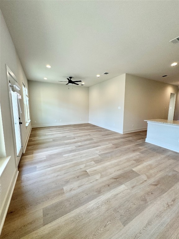 100 Zayd Court, Unit A Jarrell, TX 76537 - Photo 4 of 20 an empty room with wooden floor and windows