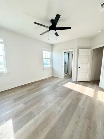 a spacious bathroom with a granite countertop sink and a mirror