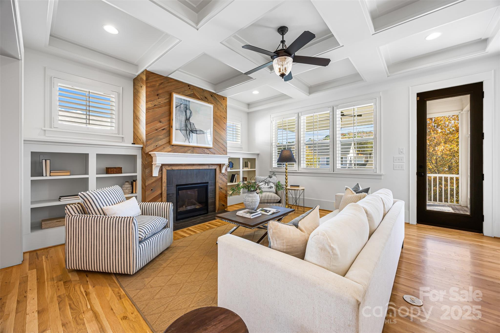 135 Inspired Way Fort Mill, SC 29708 - Photo 11 of 48 a living room with furniture a ceiling fan a fireplace and a large window